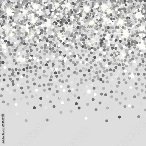 Falling silver particles on a black background. Scattered silver confetti. Rich luxury fashion backdrop. Bright shining glitter. Round dots.