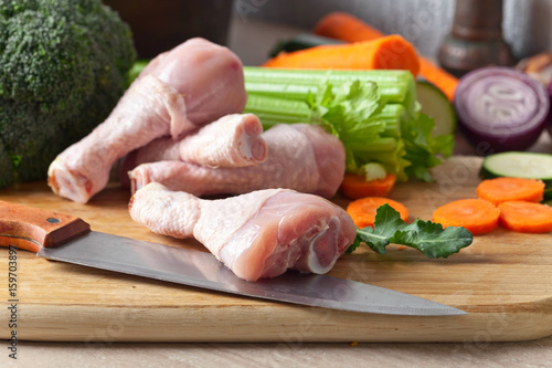 raw vegetables with chicken drumsticks