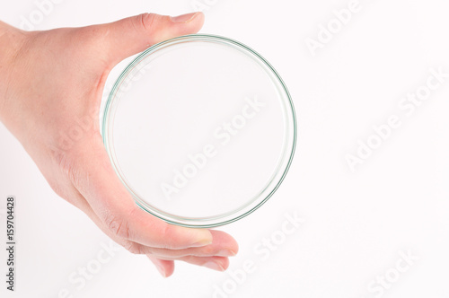 Empty petri dish for growing cultures of microorganisms in doctor hand , fungi and microbes. A Petri dish ( Petrie dish. Petri plate or cell-culture dish)