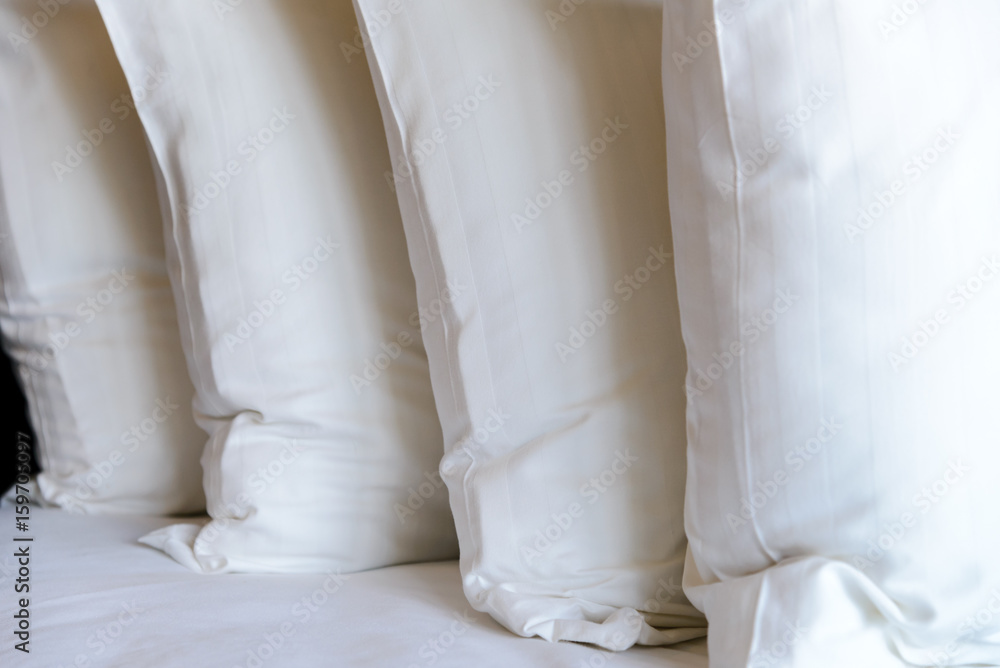 stacking of white pillows on bed - Close up stacking of white pillows on bed - Close up