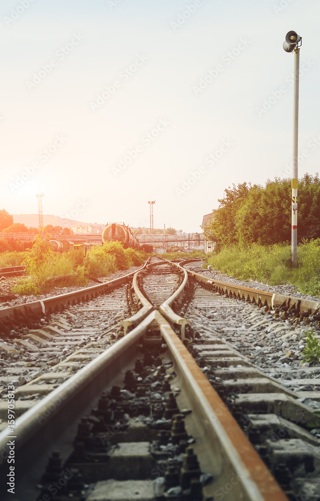 Fototapeta premium Two railways tracks merge close up.Vintage tone. Vertical photography.