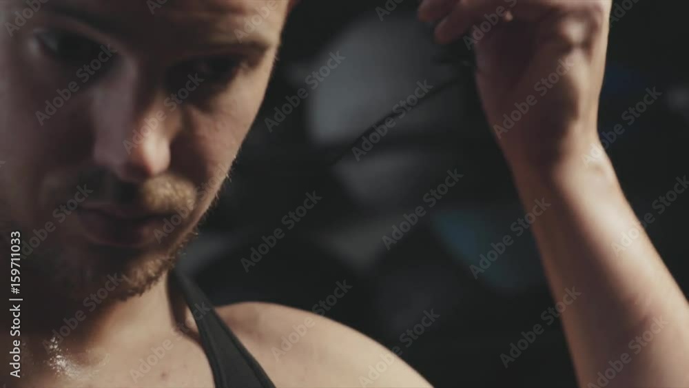 Cinematic Muscular male putting in headphones Cinematic Muscular male putting in headphones