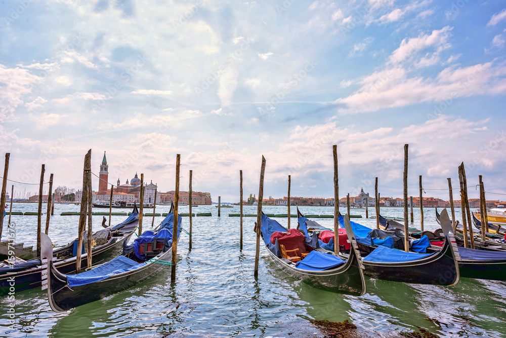 Grand canal at sunset in Venice, Piazza San Marco. On the background the island San Giorgio. Scenic cityscape with gondolas