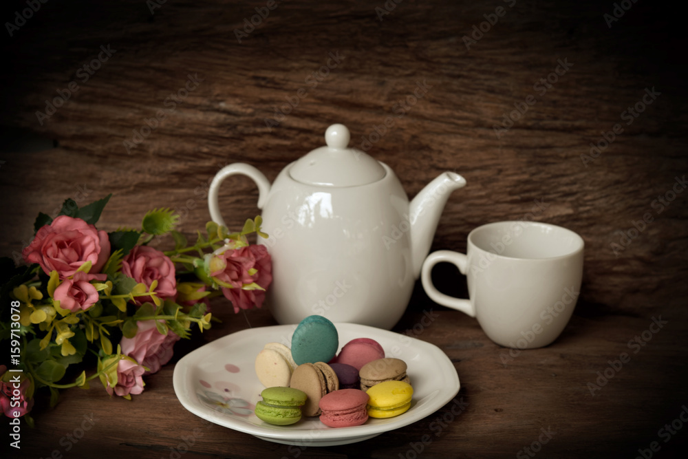 Teapot with macaroons on the wooden Teapot with macaroons on the wooden