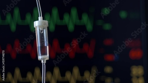 Hospital patient monitor in operating theater displaying EKG, pulse rate, blood pressure digital read out