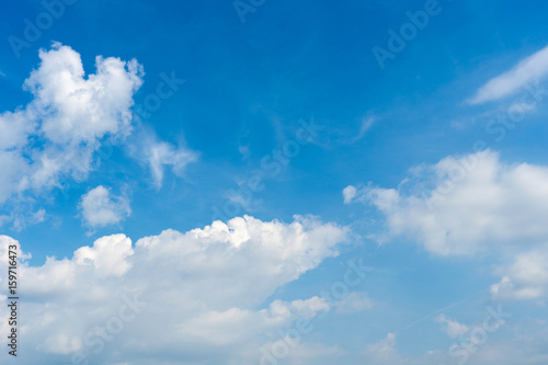 Sunny day with fluffy clouds in the blue sky