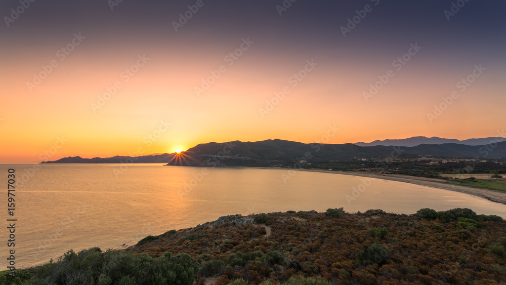 Sun rising over Lozari bay in Balagne region of Corsica