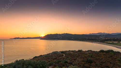 Sun rising over Lozari bay in Balagne region of Corsica