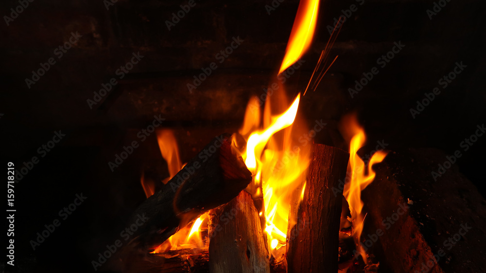 Braai barbecue wood fire coals with flames in pit - orange and red - South Africa