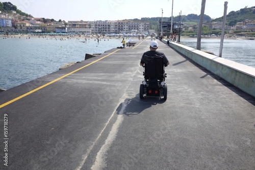 Electric wheelchair on the tourist pier