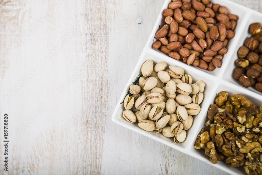 Bowl with nuts on a wooden table Bowl with nuts on a wooden table