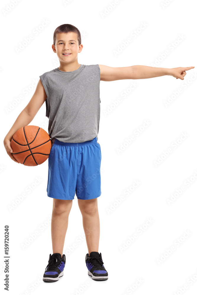 Boy with a basketball pointing right Boy with a basketball pointing right
