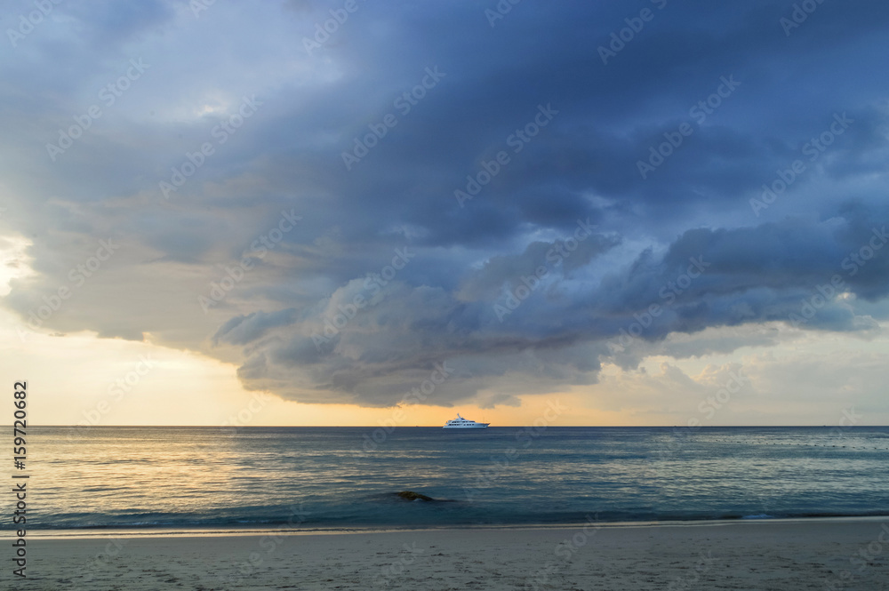 Storm clouds approaching from the roller tropical beach