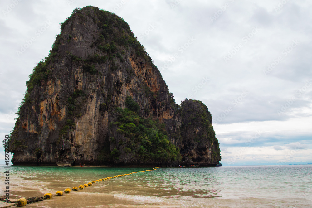 Travel to Krabi, Thailand. The scenic view on the sea and a rock from Phra Nang Beach.