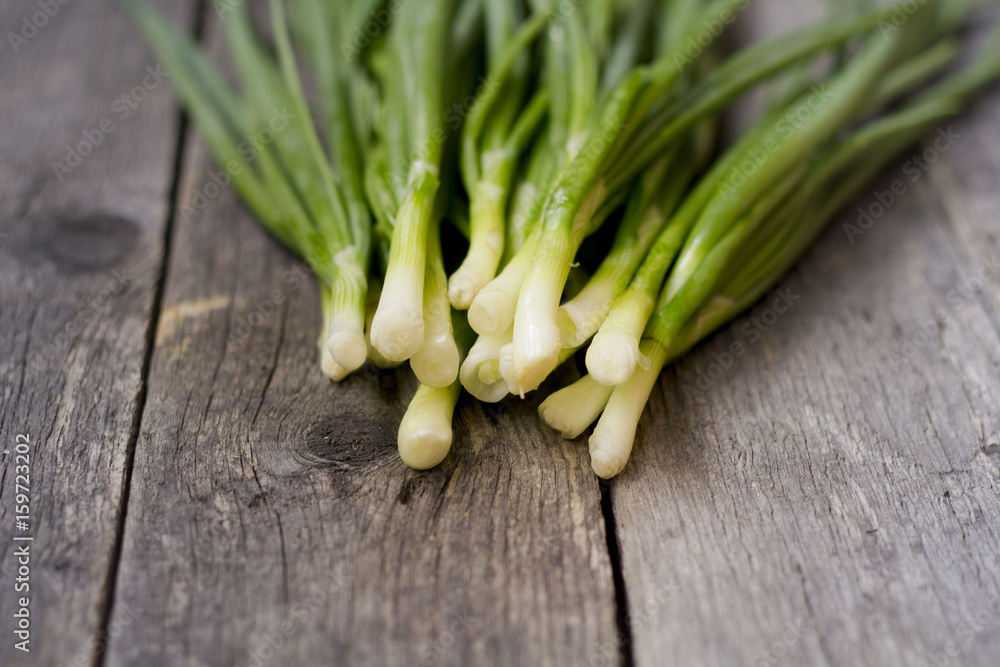 green onions on wooden background green onions on wooden background