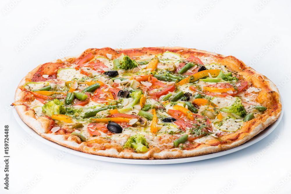 Vegetarian pizza with broccoli, green beans, olives and tomatoes on a plate Vegetarian pizza with broccoli, green beans, olives and tomatoes on a plate