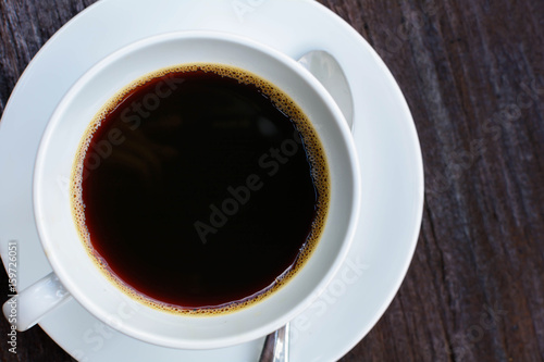 close up coffee cup clock on old wooden table nature background