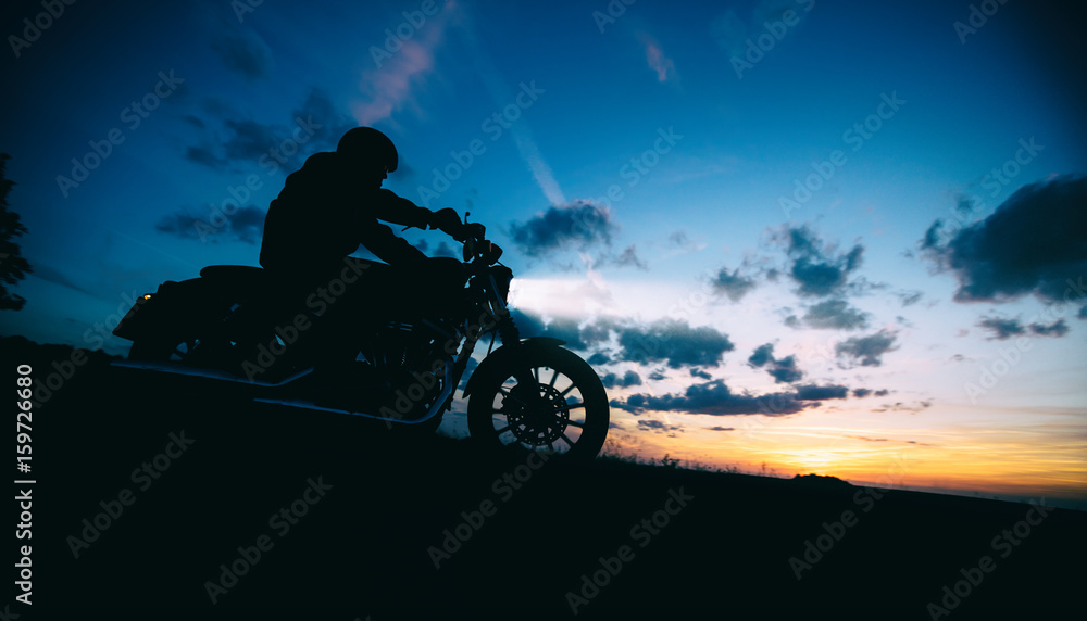 Dark motorbiker silhouette riding high power motorbike