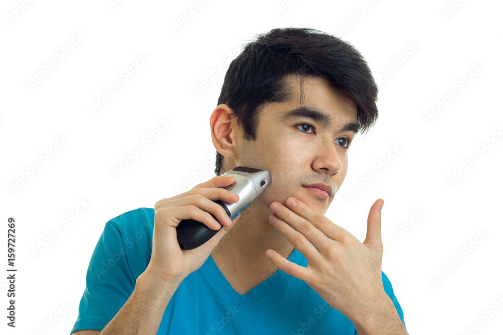 pretty young brunette man shaves a face pretty young brunette man shaves a face