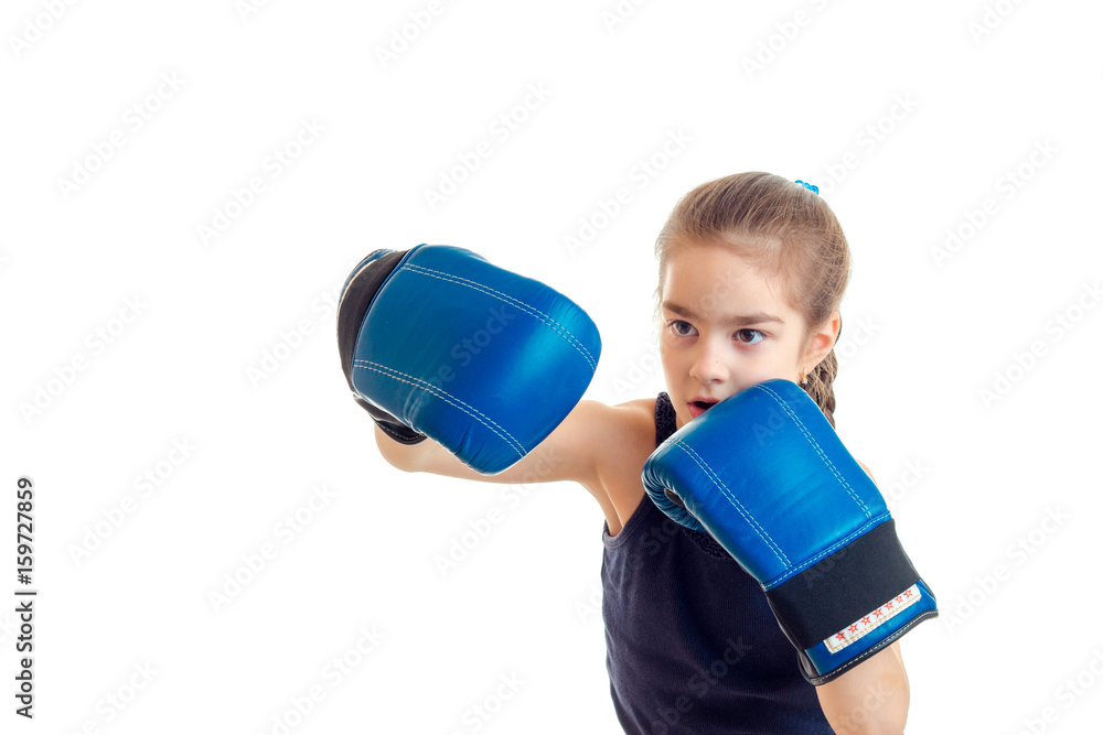 cute little girl practicing boxing in blue gloves cute little girl practicing boxing in blue gloves