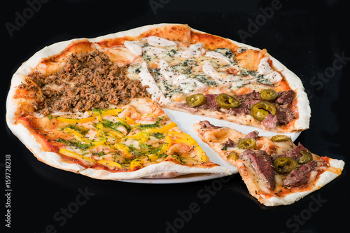 Sliced meat pizza on plate  a dark background
