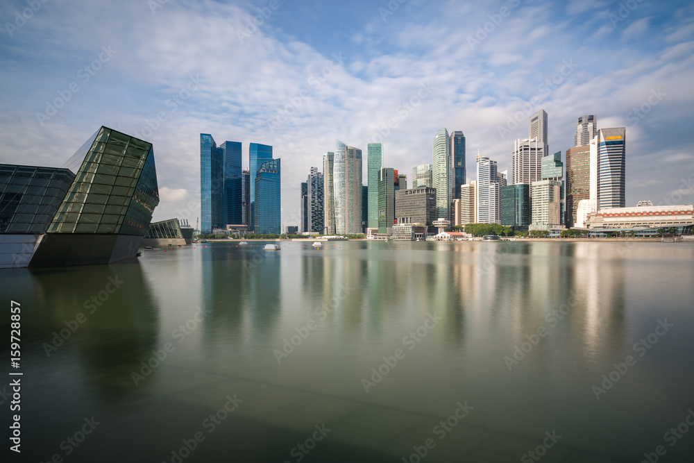 Singapore business district with skyscraper building and reflection at Marina Bay, Singapore.