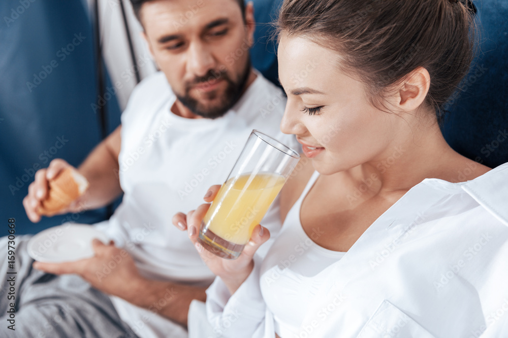 Portrait of young loving couple having breakfast in bed Portrait of young loving couple having breakfast in bed