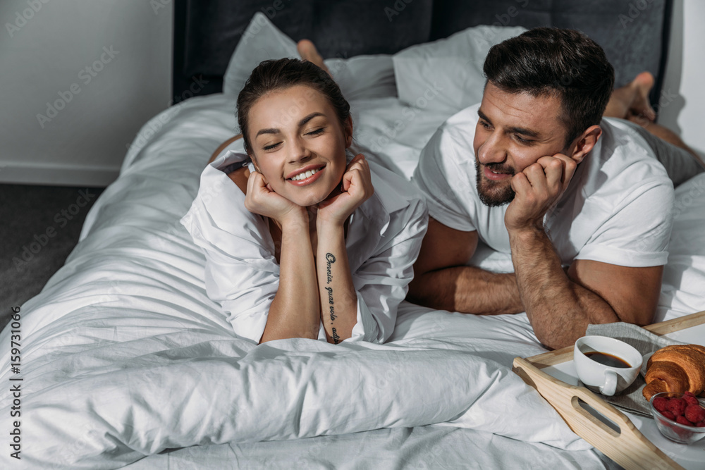 Fototapeta premium Happy couple in love having breakfast in bed