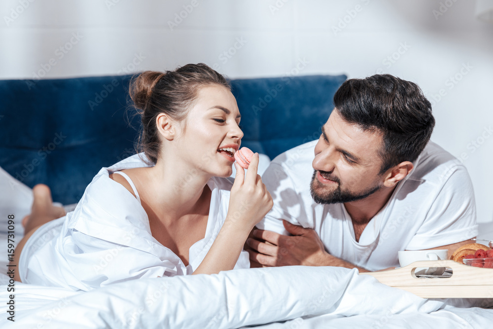 Happy couple in love having breakfast in bed Happy couple in love having breakfast in bed