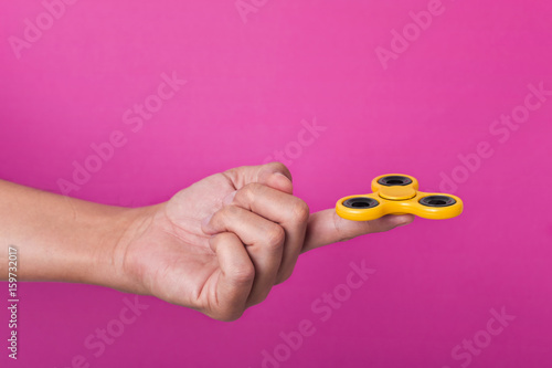 young man playing with a fidget spinner photo