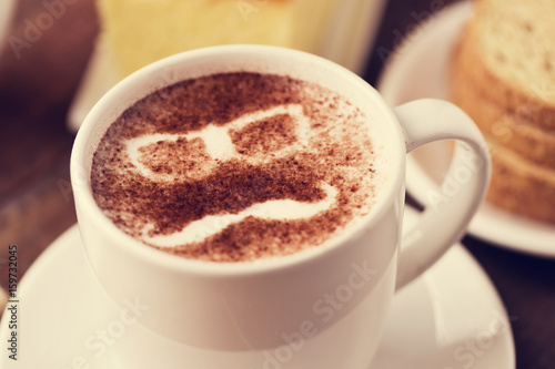 man face in a cup of cappuccino