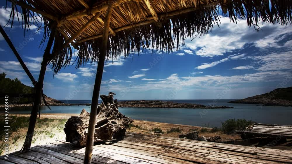 timelapse of a wooden shack on beautiful limoni beach in mljet island, croatia with stunning crystal clear water of the adriatic sea. timelapse of a wooden shack on beautiful limoni beach in mljet island, croatia with stunning crystal clear water of the adriatic sea.