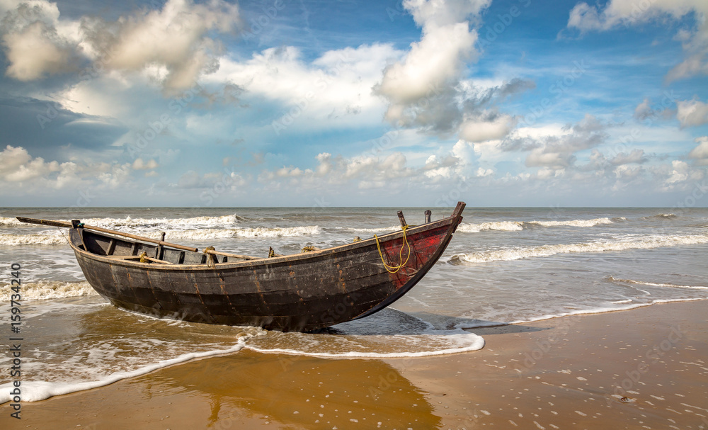 Wooden fishing boat on the sea beach at Tajpur, West Bengal India with scenic rural setup. Wooden fishing boat on the sea beach at Tajpur, West Bengal India with scenic rural setup.