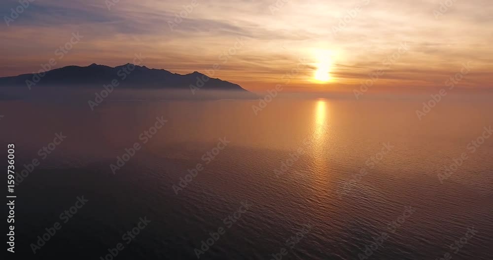 Aerial shot of beautiful sunset on the calm sea in Elba island in Tuscany, Italy, 4K Aerial shot of beautiful sunset on the calm sea in Elba island in Tuscany, Italy, 4K