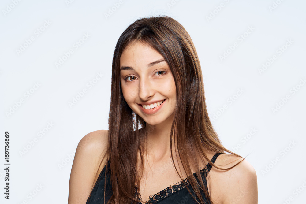 Woman with a smile and clean skin on a light background Woman with a smile and clean skin on a light background