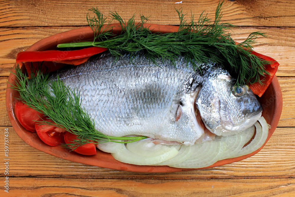 Dorado fish, sea bass prepared for cooking Dorado fish, sea bass prepared for cooking
