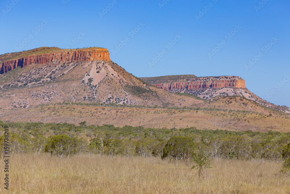 The Ramparts of the Cockburn Range stand high and proud above the ancient Kimberley landscape, concealing hidden waterfalls that plunge from the high plateau in hidden valleys.