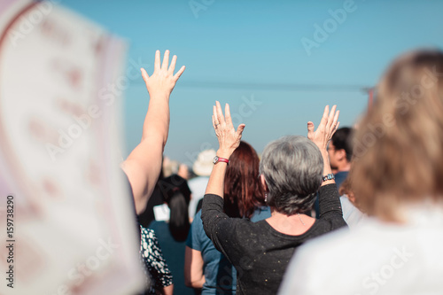 Christian praying with raised hand worship.