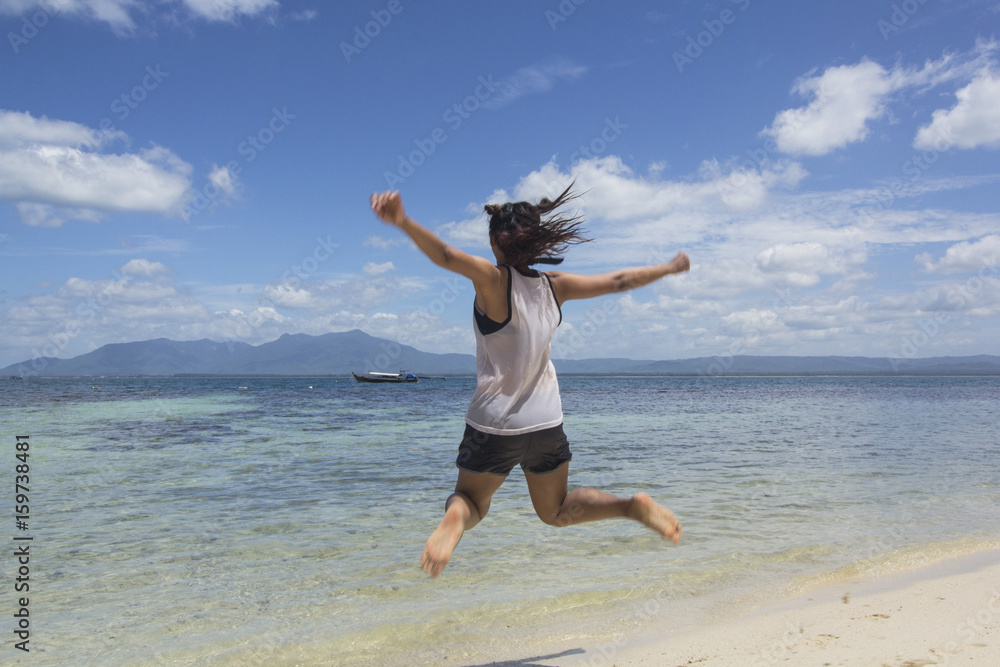 The girl jumped gladly on the beach vacation. Prachuap Khiri Khan, Thailand.jpg