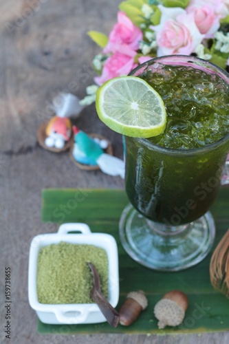 Iced green tea with lemon and matcha tea powder.