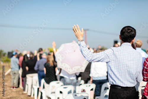Christian praying with raised hand worship.