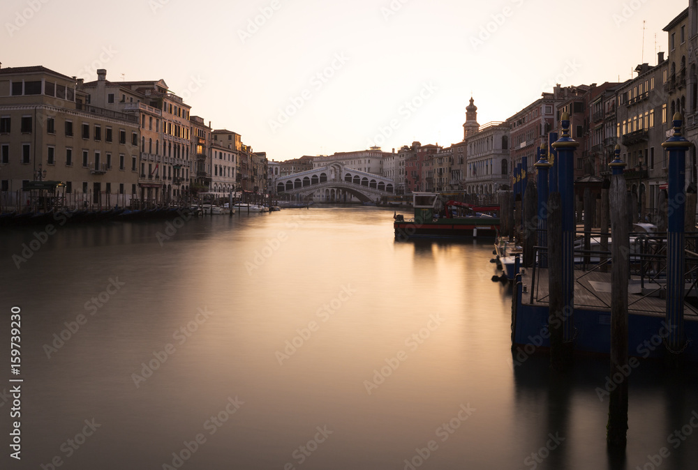 View onto the Canal Grande and the Rialto bridge in Venice at sunrise.