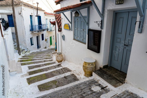 Fototapeta Naklejka Na Ścianę i Meble -  Narrow street with stairs and traditional houses in the old town of Koroni in Peloponnese, Greece