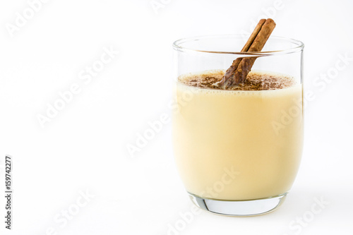 Homemade eggnog with cinnamon isolated on white background. Typical Christmas dessert.

