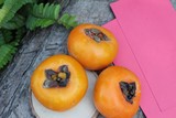 persimmons fruit with red envelopes, Chinese New Year.