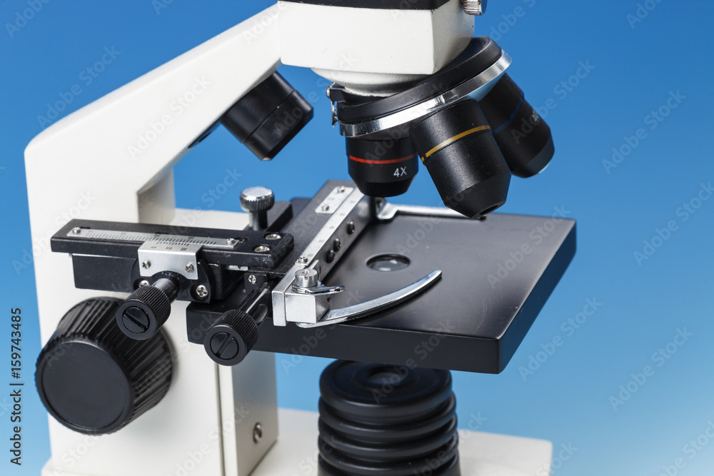 Naklejka premium Subject table microscope and interchangeable lenses. Microscope is the main research tool in many scientific laboratories