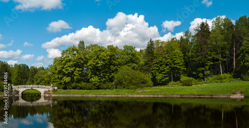 Fototapeta Naklejka Na Ścianę i Meble -  Lake with a stone bridge in the city park