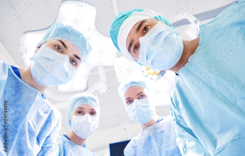 group of surgeons in operating room at hospital