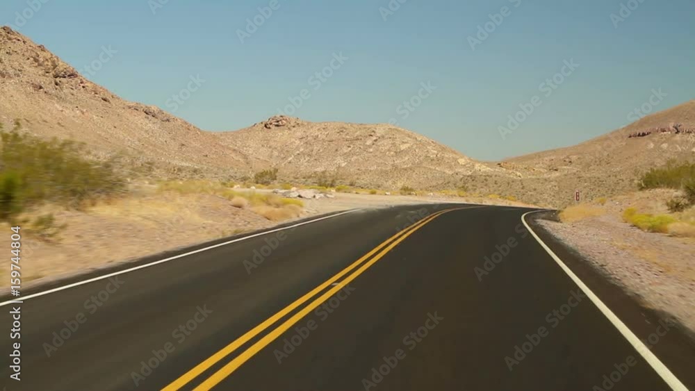Driving shot on an empty road in Death Valley National Park. Driving shot on an empty road in Death Valley National Park.