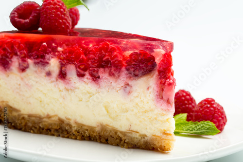 Raspberry cheesecake on white background.